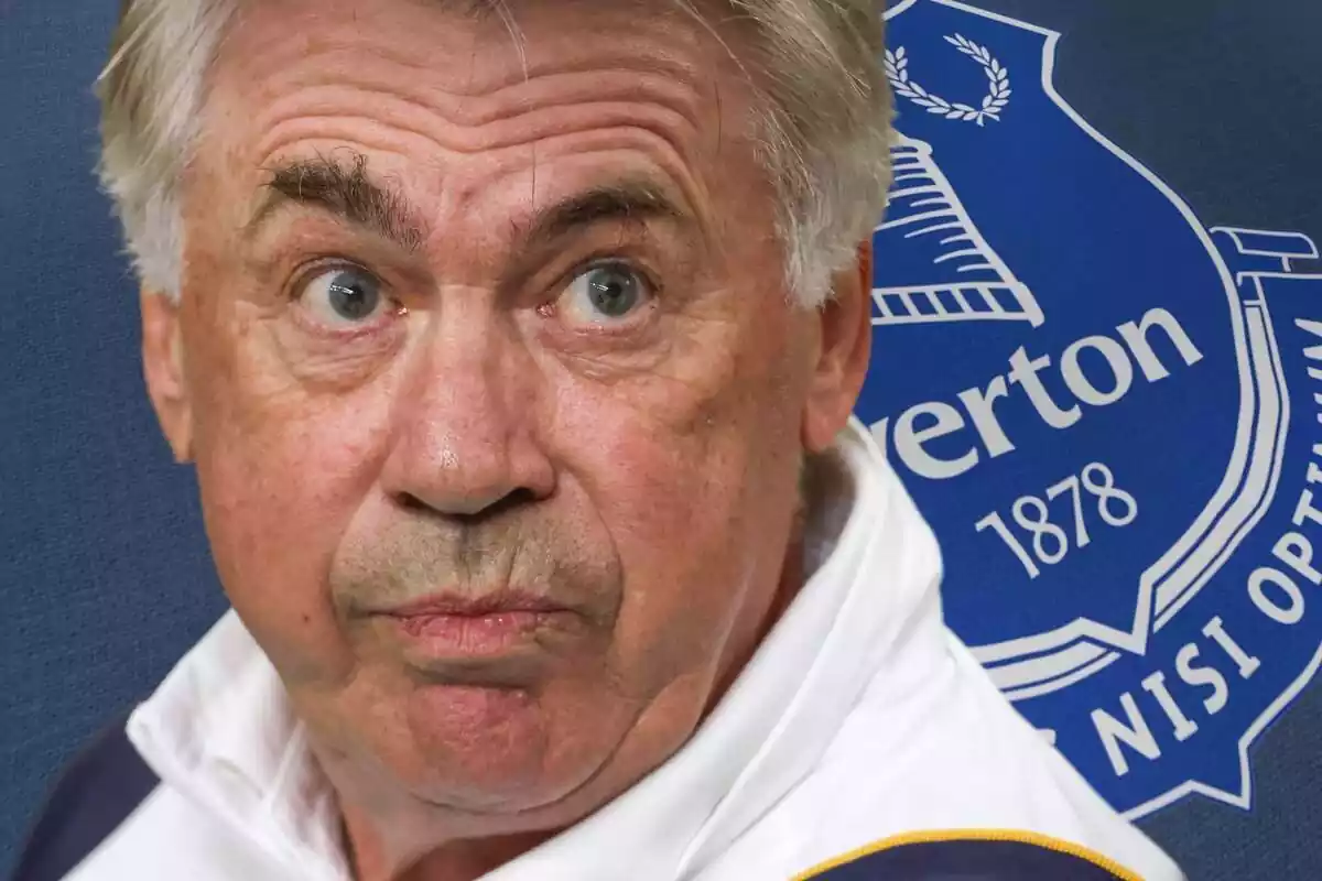 Carlo Ancelotti with a scared face and eyes wide open next to an Everton shield