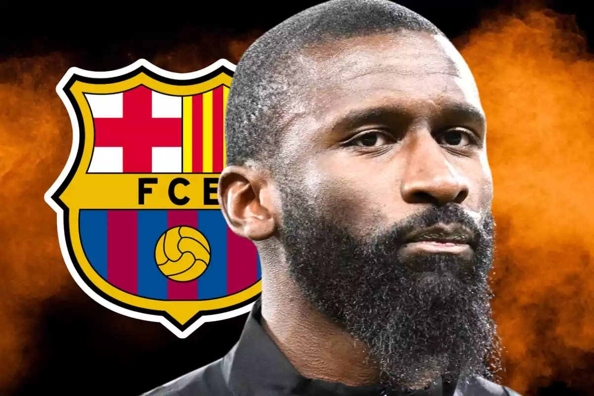 A bearded man in front of the FC Barcelona crest.