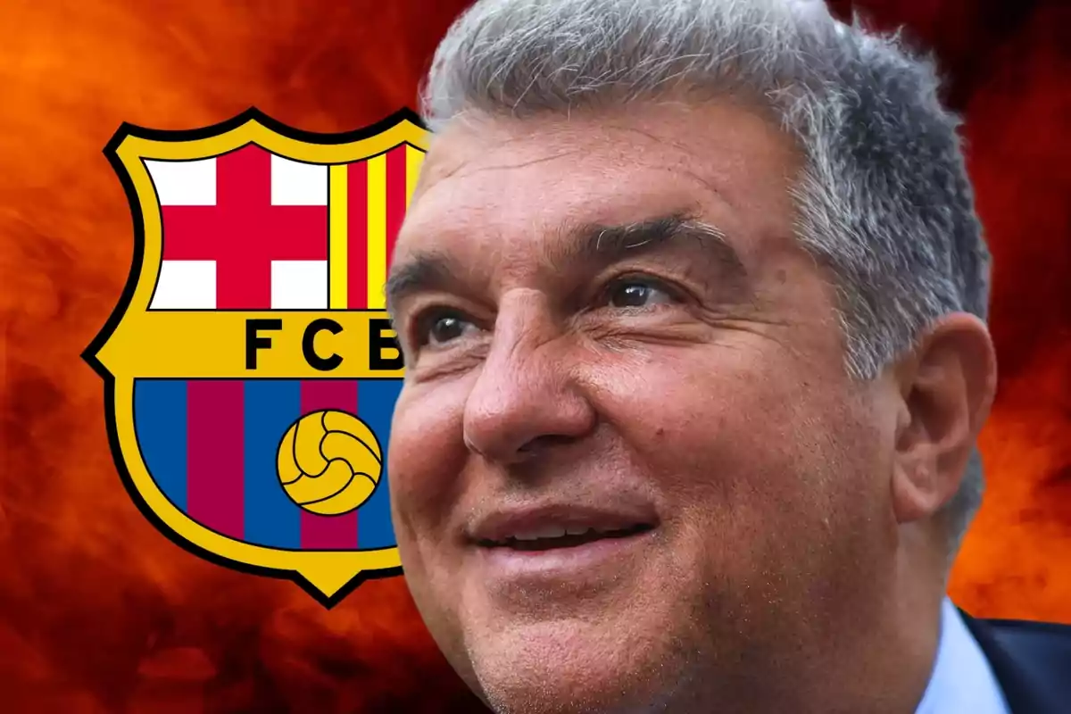 Smiling man with grey hair in front of the FC Barcelona crest on a warm coloured background.