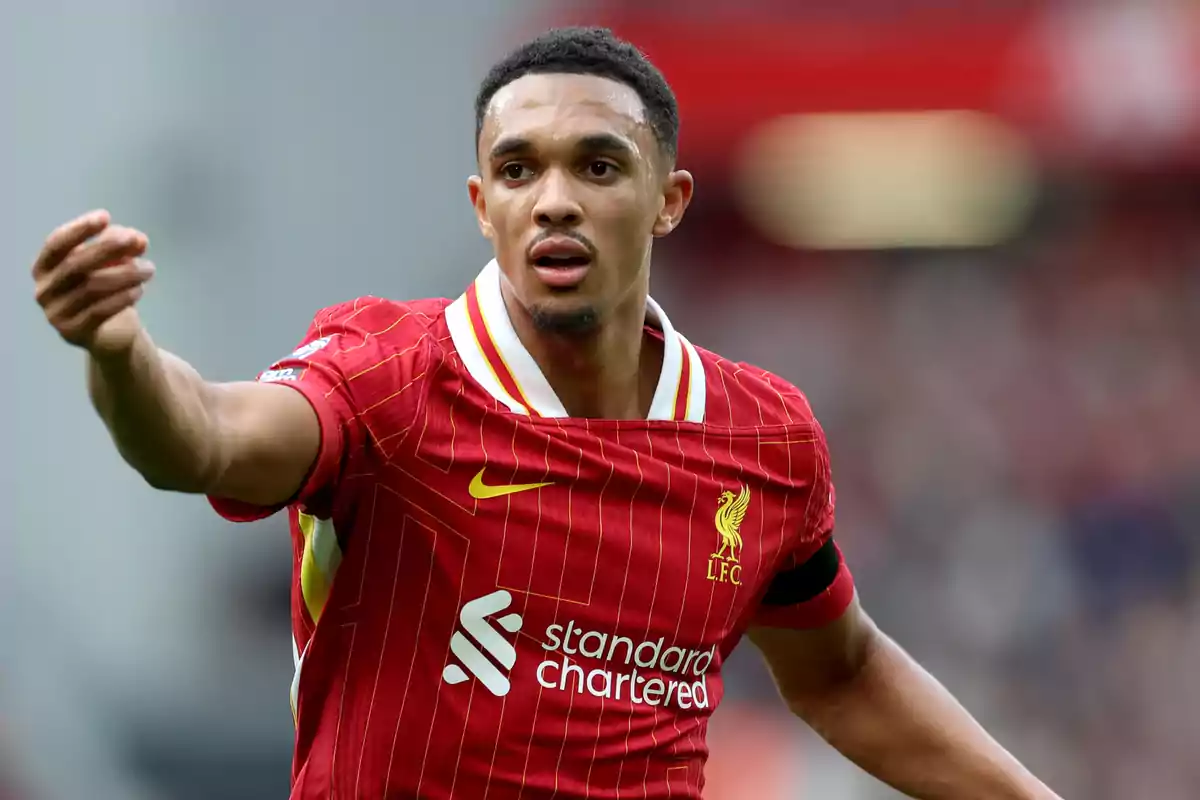 A football player in the red Liverpool uniform on the field.