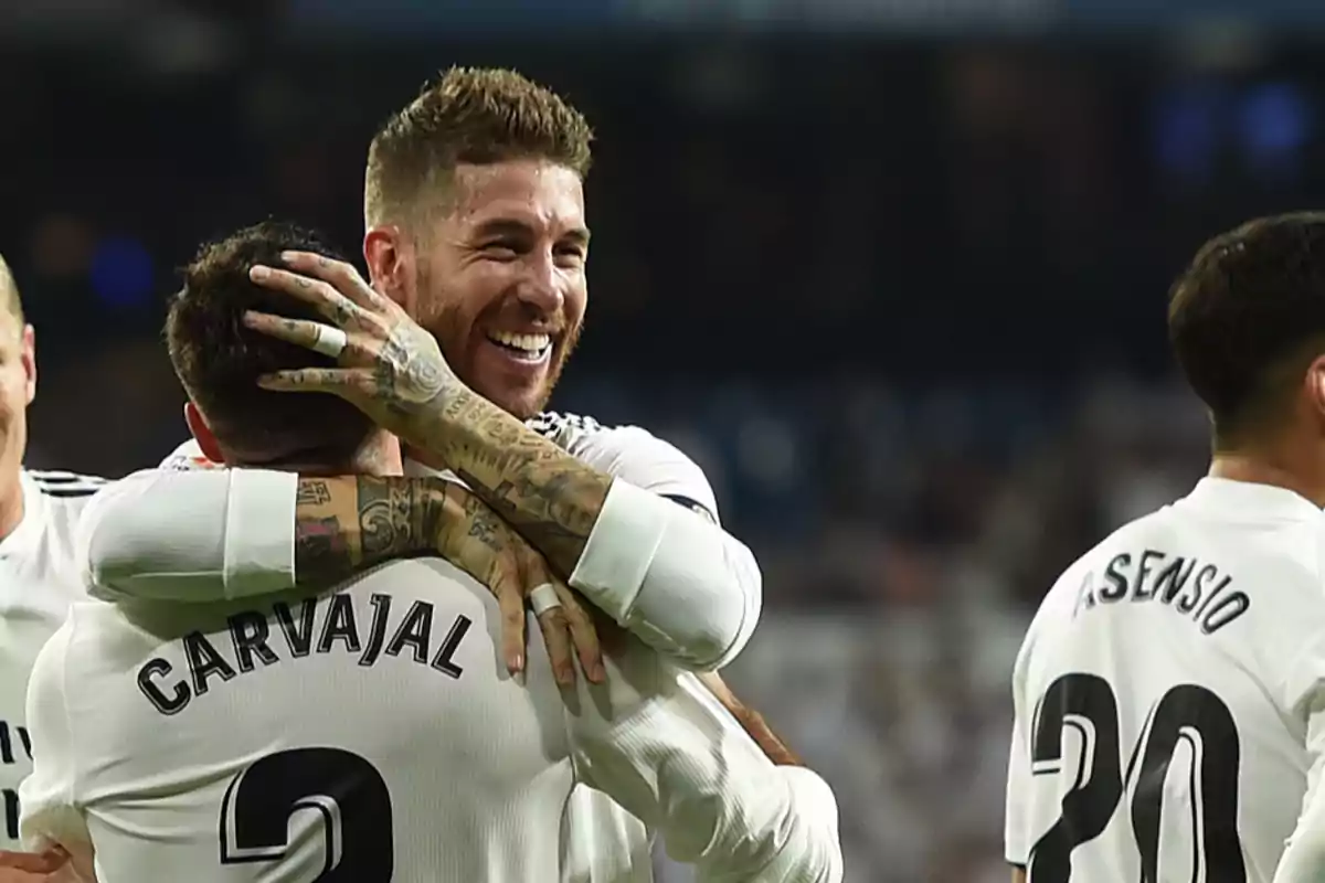 Football players celebrating a goal on the field.