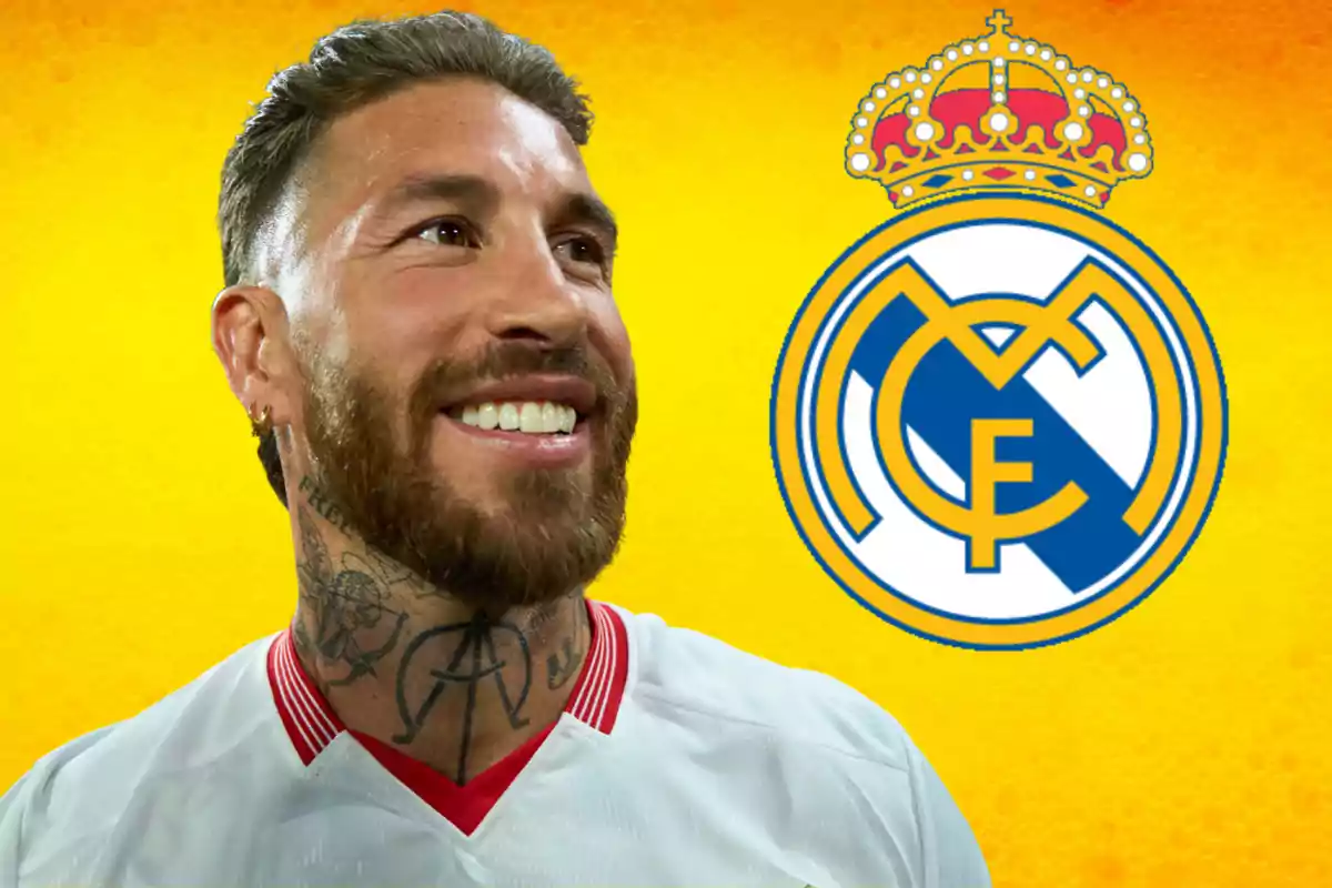 A smiling man with a beard and tattoos on his neck, wearing a white t-jersey, with the Real Madrid crest on a yellow background.