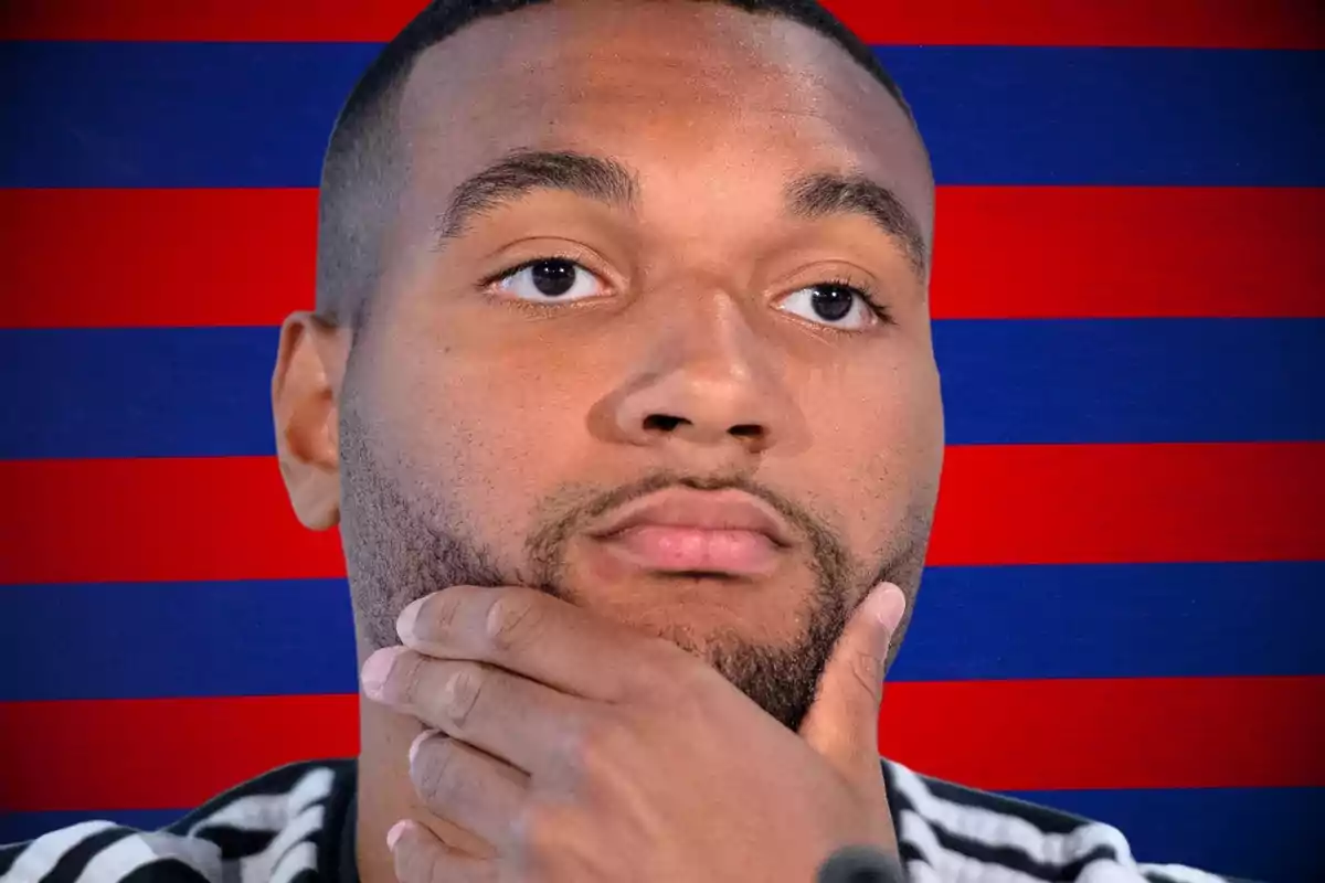 A bearded man with a thoughtful expression in front of a red and blue striped background.